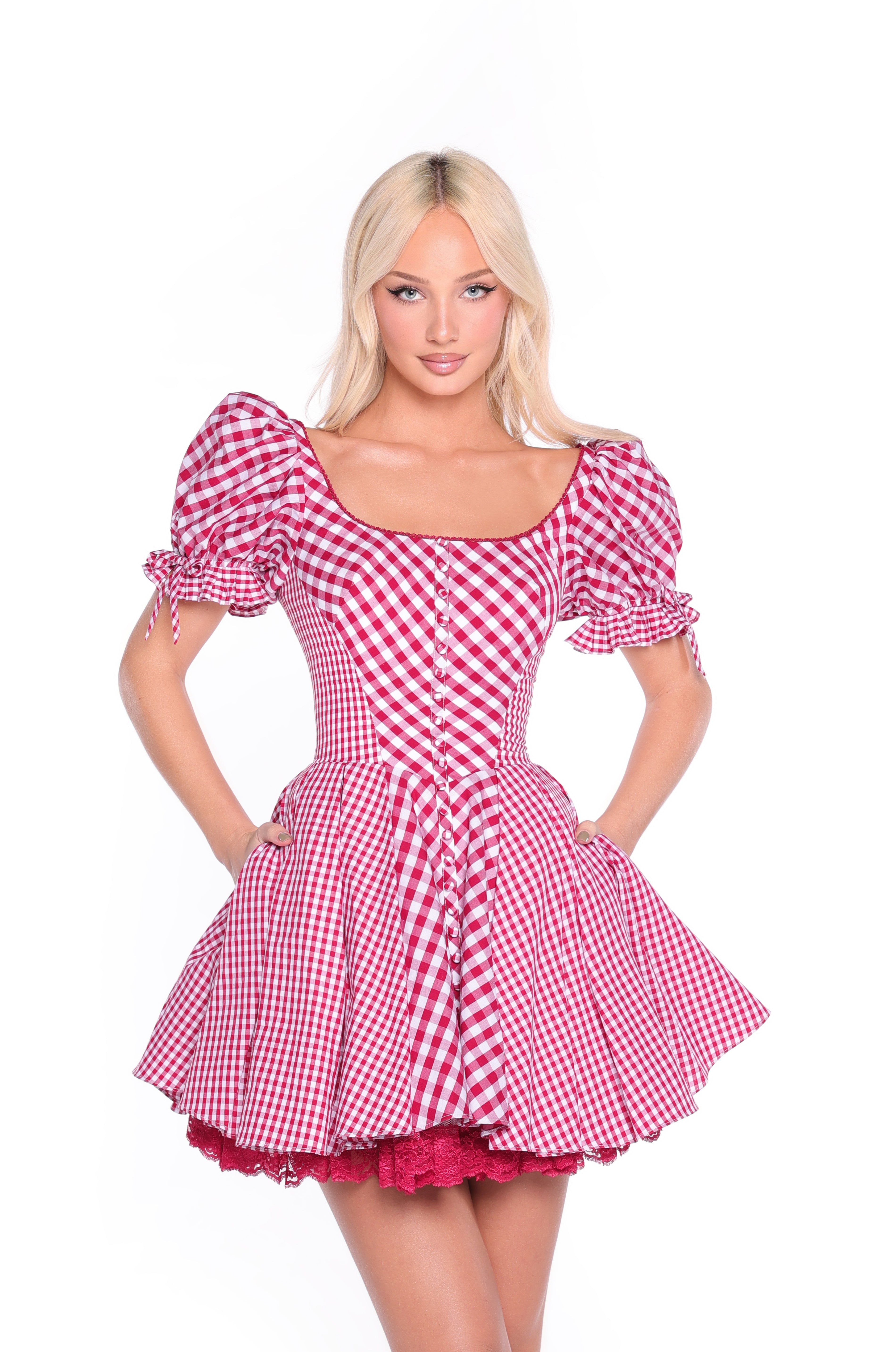 A woman wears the Cherry Gingham Short Casual Dress: Roslyn, featuring puffed sleeves and a flared skirt, standing against a white background.
